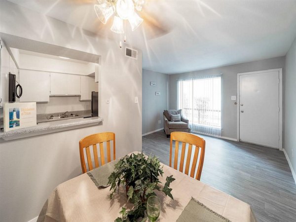 Dining room featuring elegant table setting and modern lighting at Carelton Courtyard Apartments