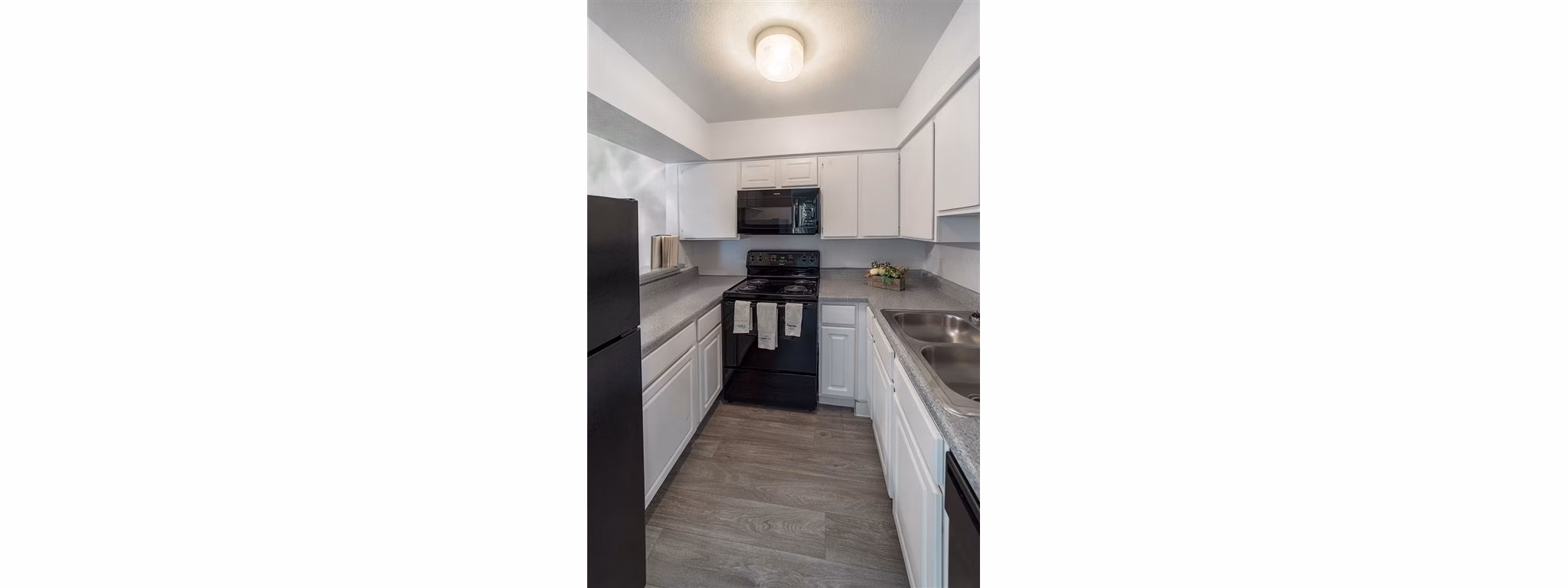 Modern kitchen featuring stainless steel appliances in Carelton Courtyard apartments