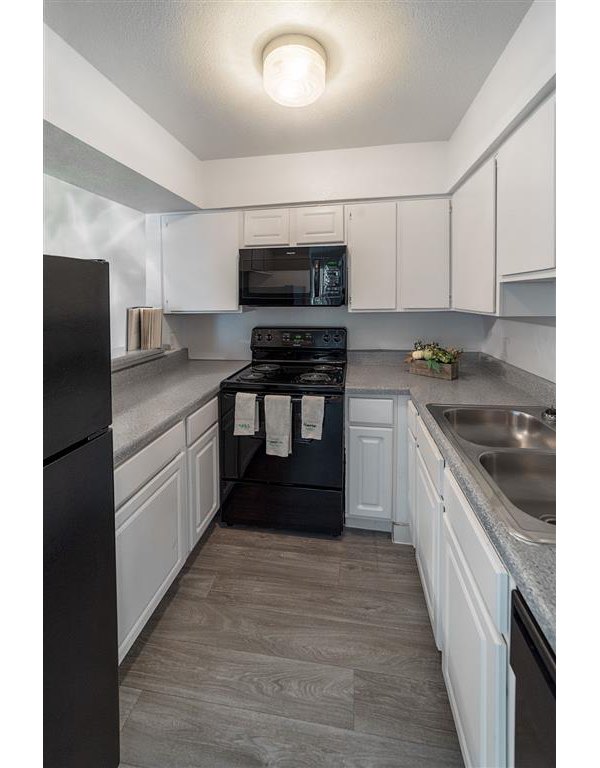 Modern kitchen featuring stainless steel appliances in Carelton Courtyard apartments