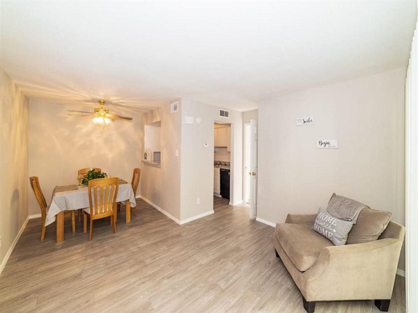 Spacious living room with modern furnishings and natural light in Carelton Courtyard Apartments