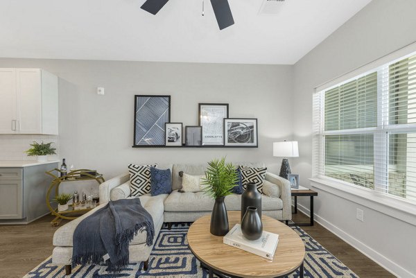 Living room with contemporary furnishings at Indigo at Berewick Apartments