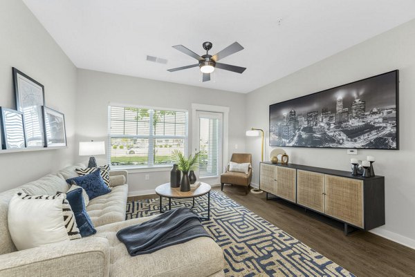 Spacious living room with cozy seating and modern decor in Indigo at Berewick Apartments