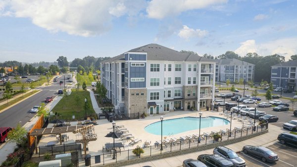 Indigo at Berewick: Stunning outdoor pool with relaxing lounge chairs and lush landscaping