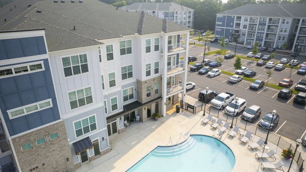 Indigo at Berewick Apartments: Sparkling outdoor pool area with lush landscaping