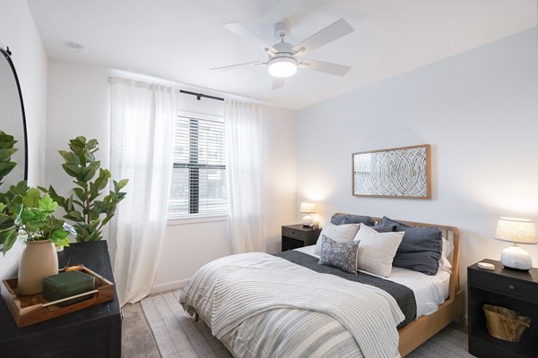Cozy bedroom with modern decor at Citizen House MLK Apartments