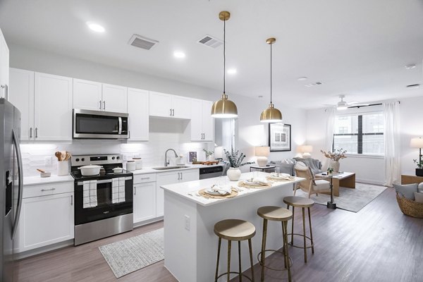 Modern kitchen with stainless steel appliances at Citizen House MLK Apartments in Austin