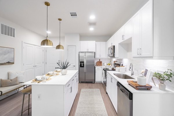 Modern kitchen with stainless steel appliances at Citizen House MLK Apartments, offering luxury living spaces in the heart of the community