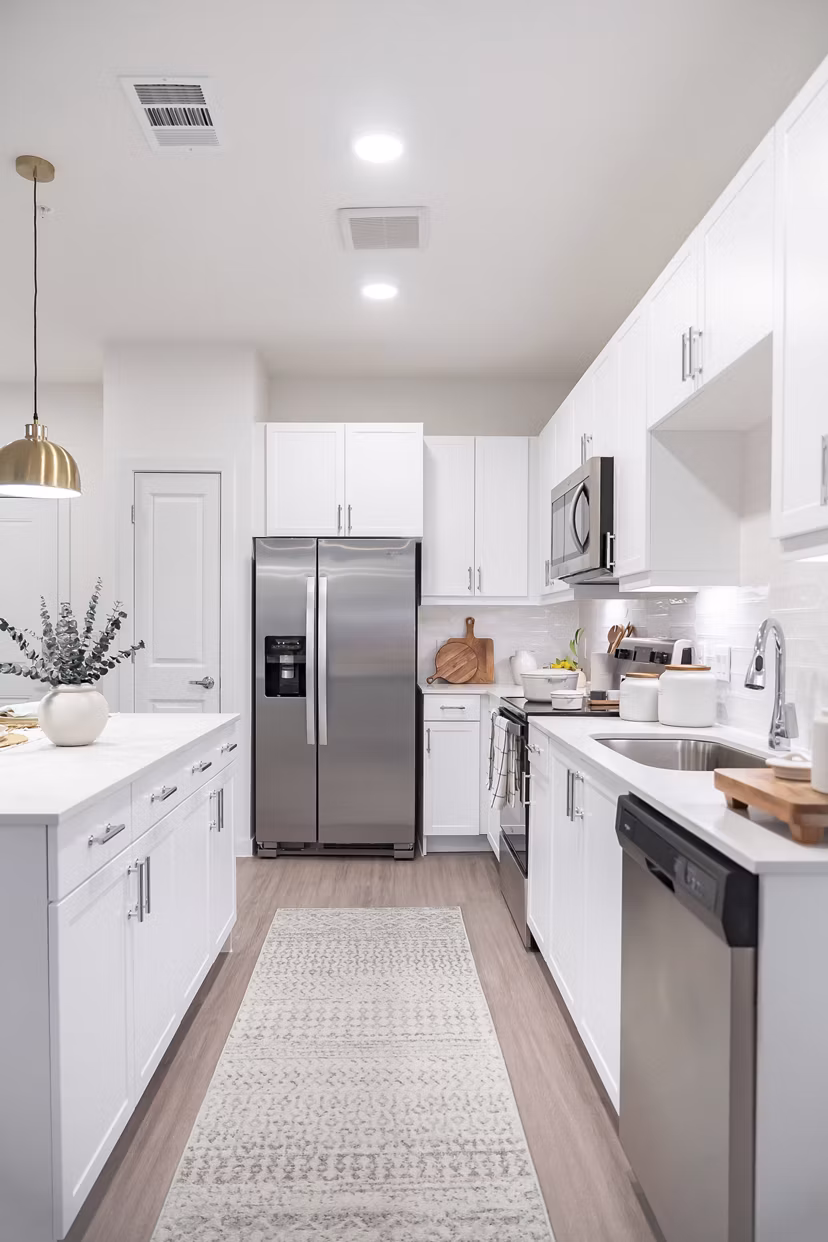 Modern kitchen with stainless steel appliances in Citizen House MLK Apartments
