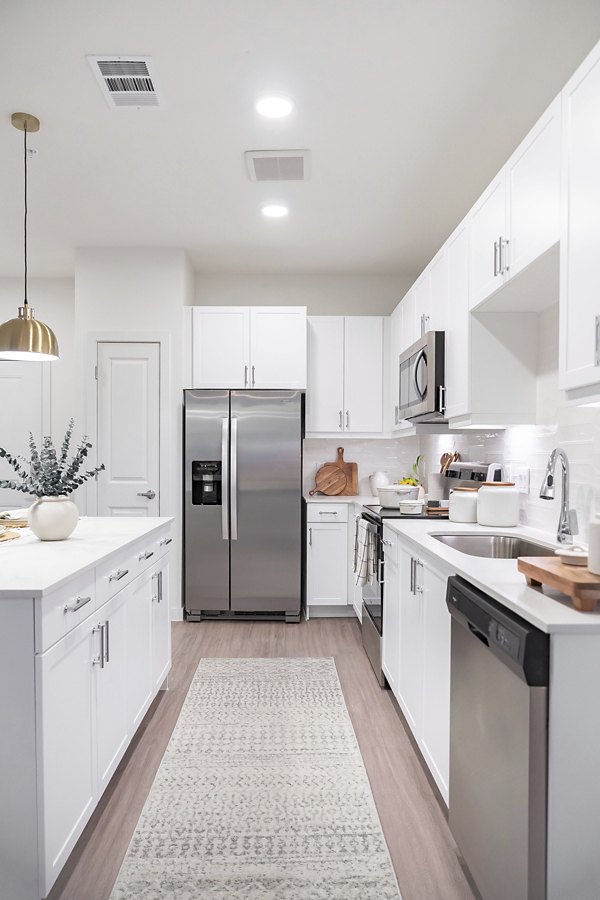 Modern kitchen with stainless steel appliances in Citizen House MLK Apartments