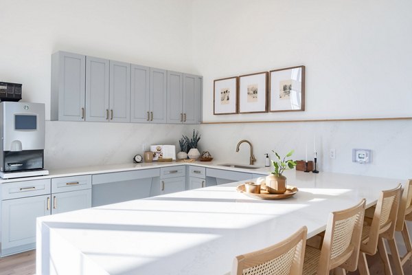 Modern kitchen with stainless steel appliances in Citizen House MLK Apartments