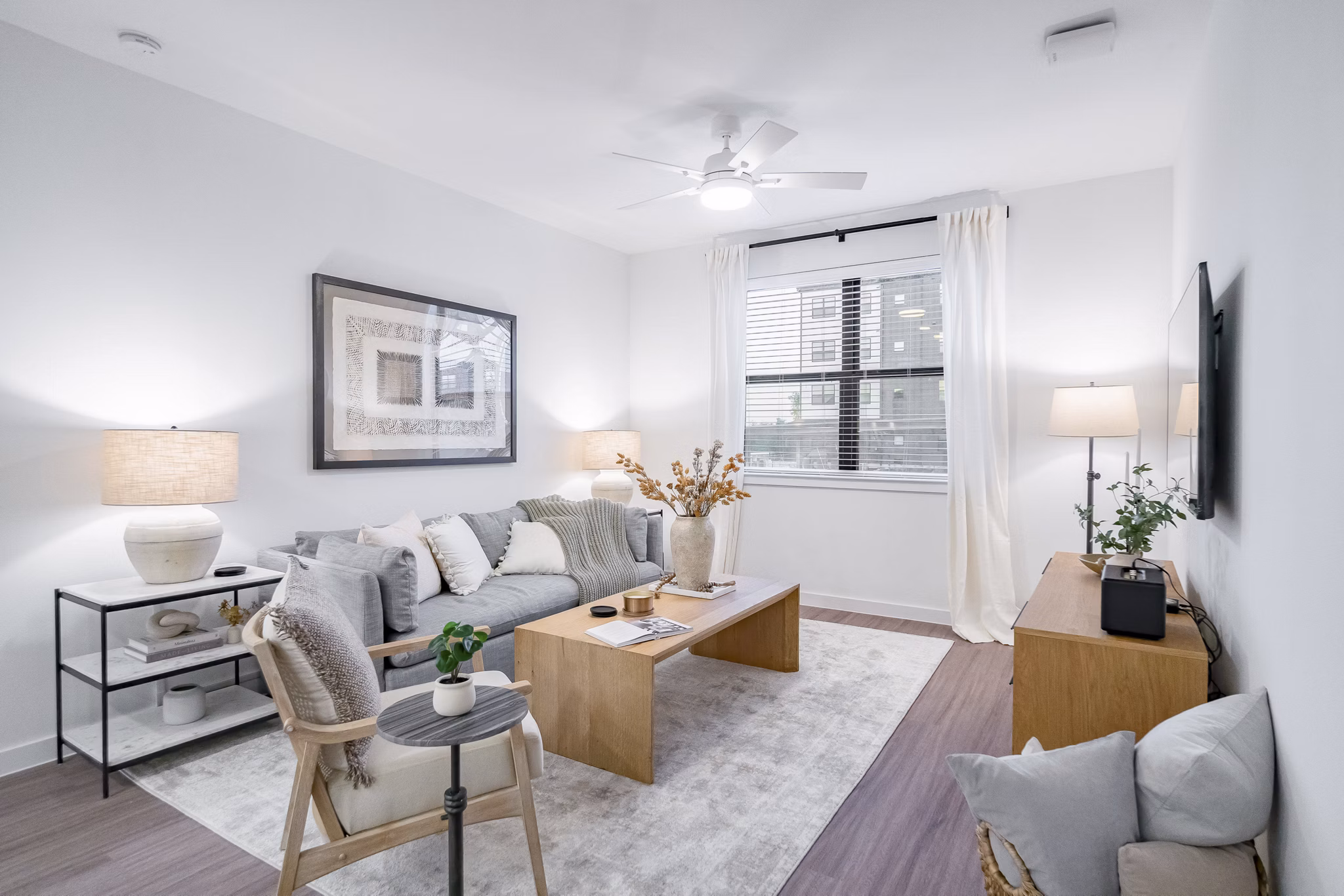 Modern living room with stylish decor at Citizen House MLK Apartments, featuring comfortable seating and open layout