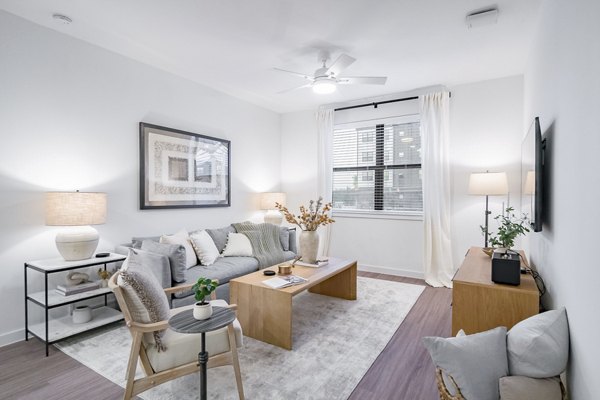 Modern living room with stylish decor at Citizen House MLK Apartments, featuring comfortable seating and open layout