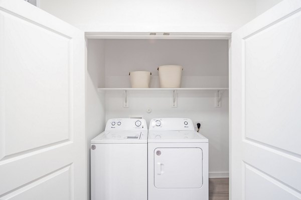 Laundry room with modern appliances at Citizen House MLK Apartments, luxury living by Greystar