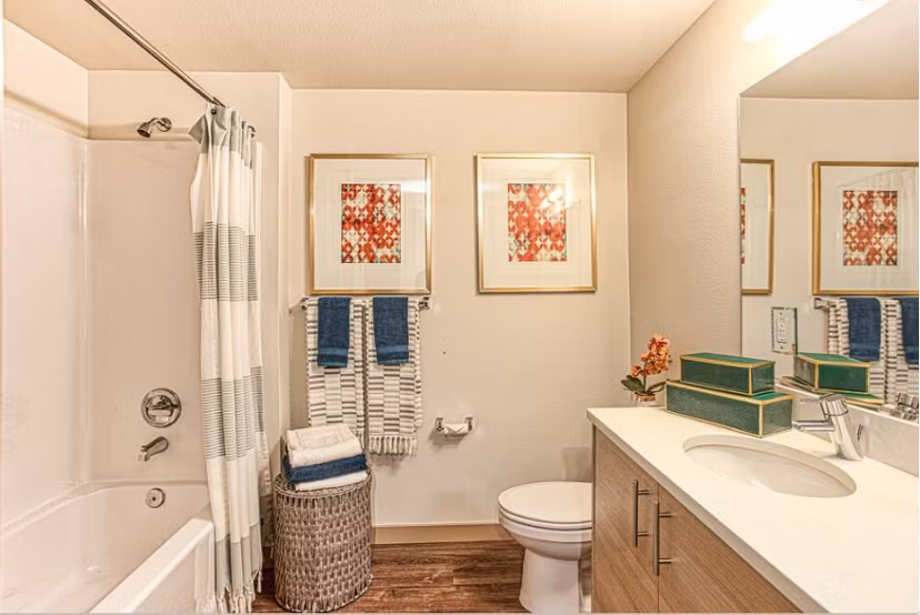 Bathroom with sleek fixtures and white tiles at Ethos Apartments