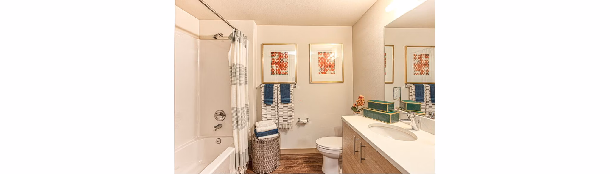 Bathroom with sleek fixtures and white tiles at Ethos Apartments