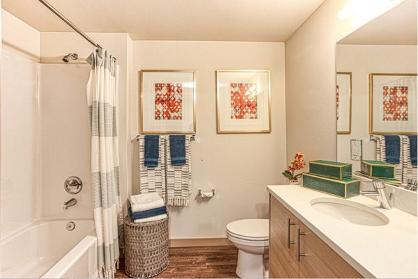 Bathroom with sleek fixtures and white tiles at Ethos Apartments