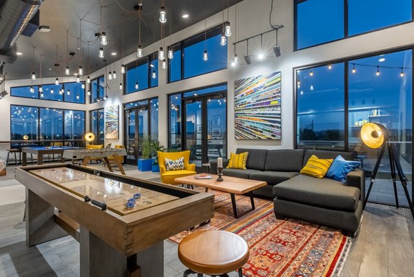 Modern social clubhouse at Ethos Apartments featuring upscale seating and entertainment areas