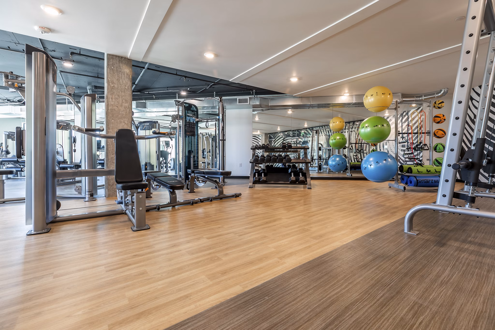 State-of-the-art fitness center at Ethos Apartments equipped with cardio machines and free weights for active lifestyle enthusiasts
