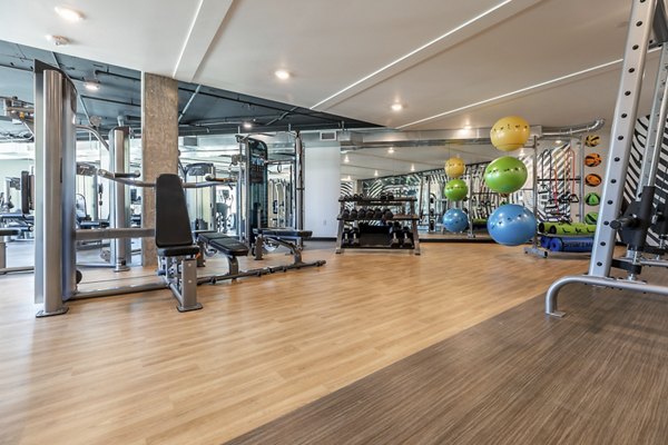 State-of-the-art fitness center at Ethos Apartments equipped with cardio machines and free weights for active lifestyle enthusiasts