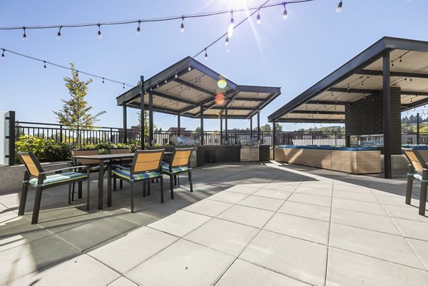 Ethos Apartments: Tranquil courtyard with modern seating in vibrant community setting