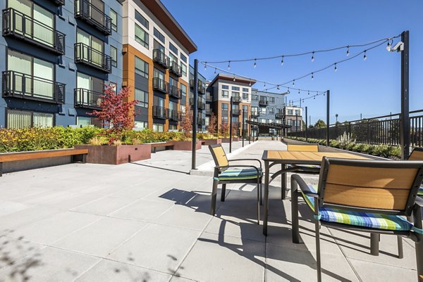 Tranquil garden courtyard at Ethos Apartments featuring lush greenery and seating areas