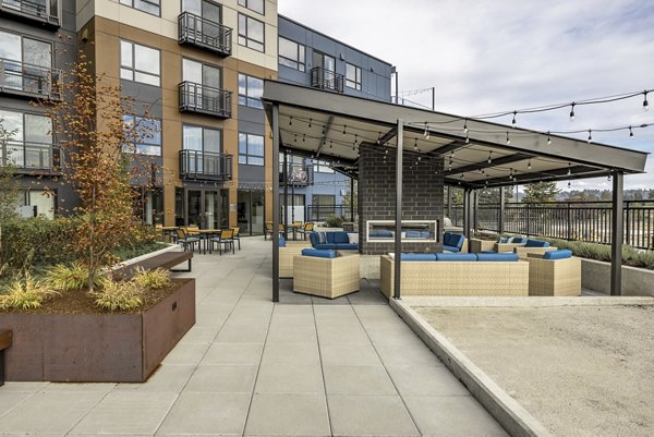 Courtyard at Ethos Apartments: Stylish outdoor gathering space with modern seating and lush landscaping