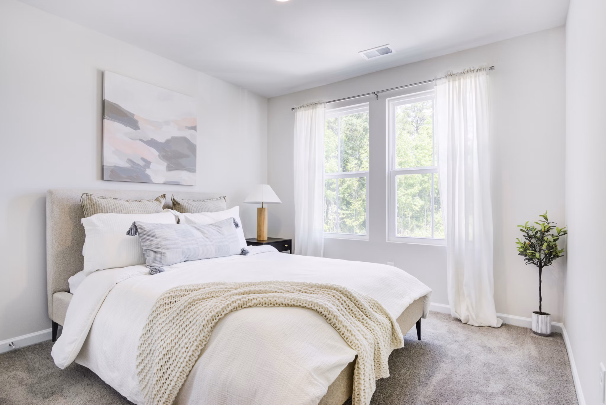 Cozy bedroom with modern decor at Berkeley Homes Apartments, a luxury offering by Greystar in a prime location