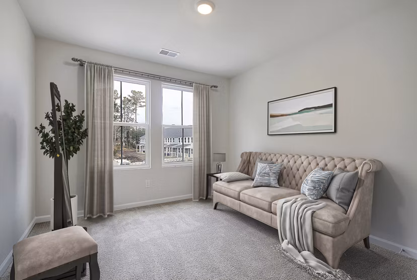 Comfortable home office/bedroom featuring modern desk and cozy decor at Berkeley Homes Apartments