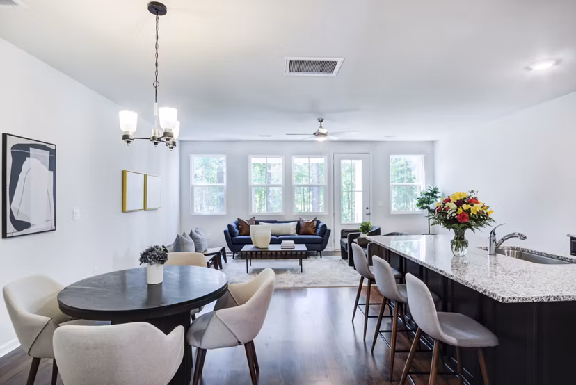 Spacious living room with modern furnishings and large windows at Berkeley Homes Apartments