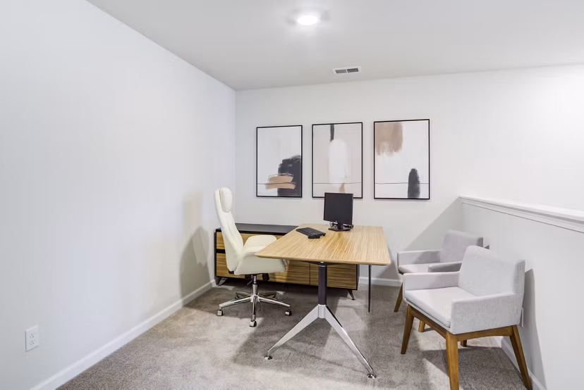 Home office setup with ergonomic chair and desk at Berkeley Homes Apartments