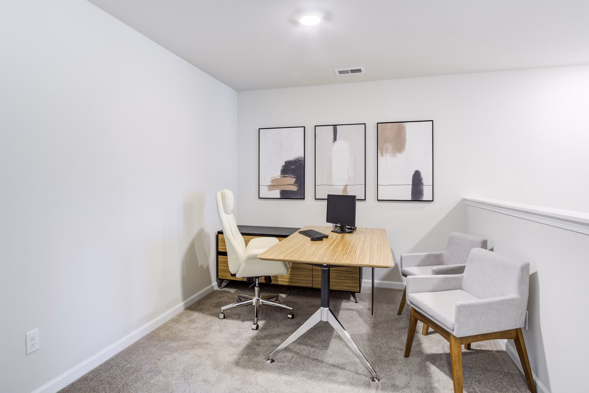 Home office setup with ergonomic chair and desk at Berkeley Homes Apartments