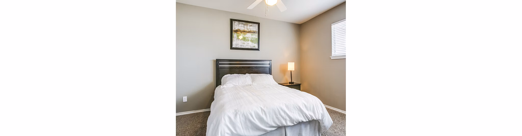 Cozy bedroom with elegant furnishings at Equinox on the Park Apartments