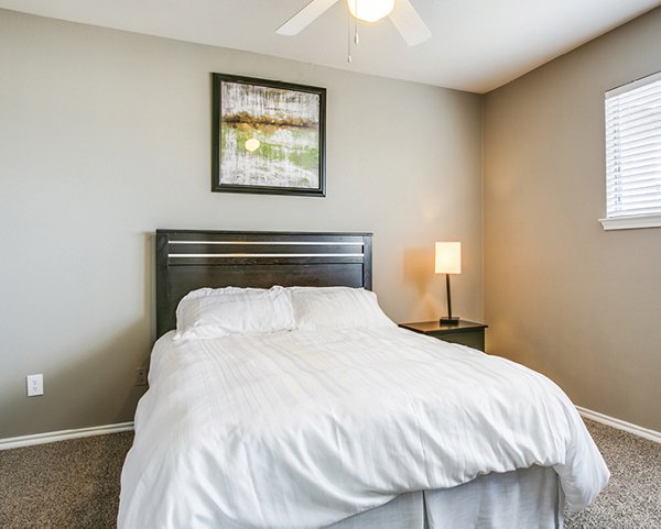 Cozy bedroom with elegant furnishings at Equinox on the Park Apartments