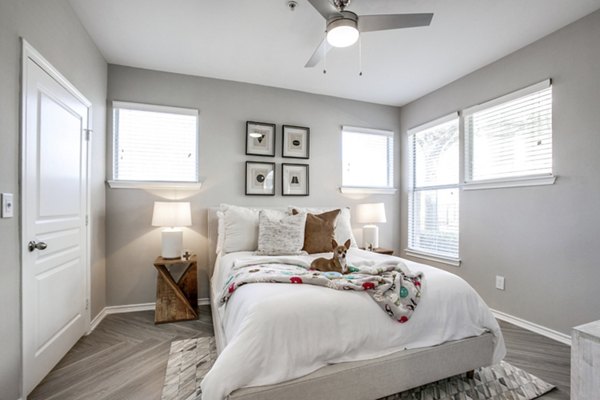Cozy bedroom with plush bedding at Equinox on the Park Apartments, a luxury living experience