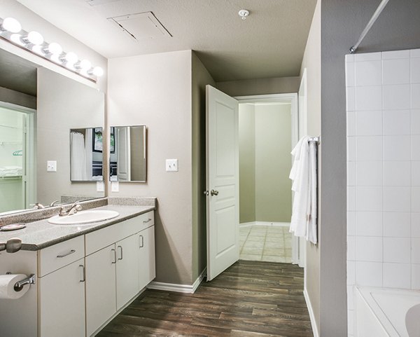 Modern bathroom with sleek fixtures in Equinox on the Park Apartments