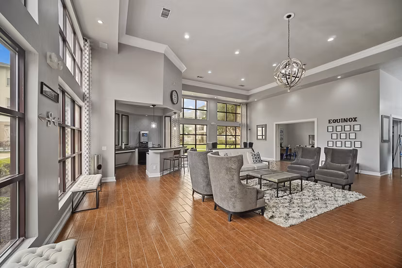 Modern clubhouse with spacious seating at Equinox on the Park Apartments, offering luxurious amenities and community events for residents