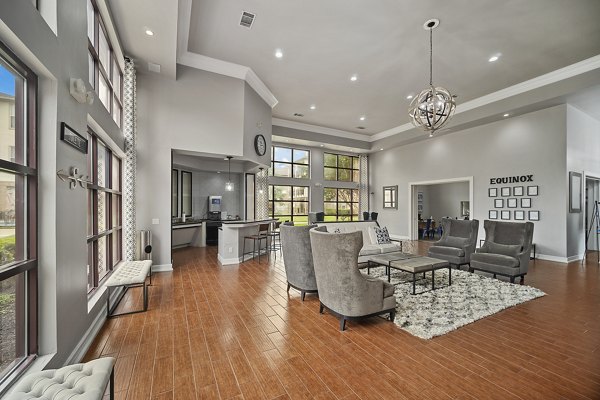Modern clubhouse with spacious seating at Equinox on the Park Apartments, offering luxurious amenities and community events for residents