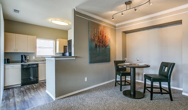 Dining area featuring elegant furnishings and modern lighting at Equinox on the Park Apartments