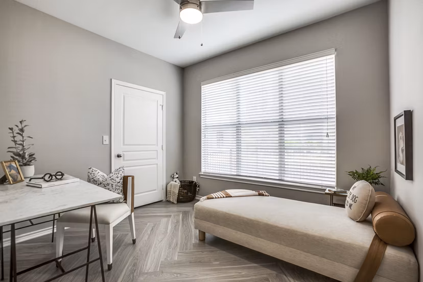 Home office with sleek desk and ergonomic chair at Equinox on the Park Apartments