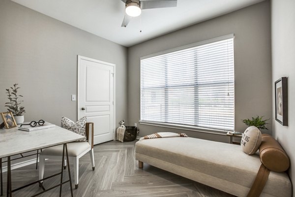 Home office with sleek desk and ergonomic chair at Equinox on the Park Apartments