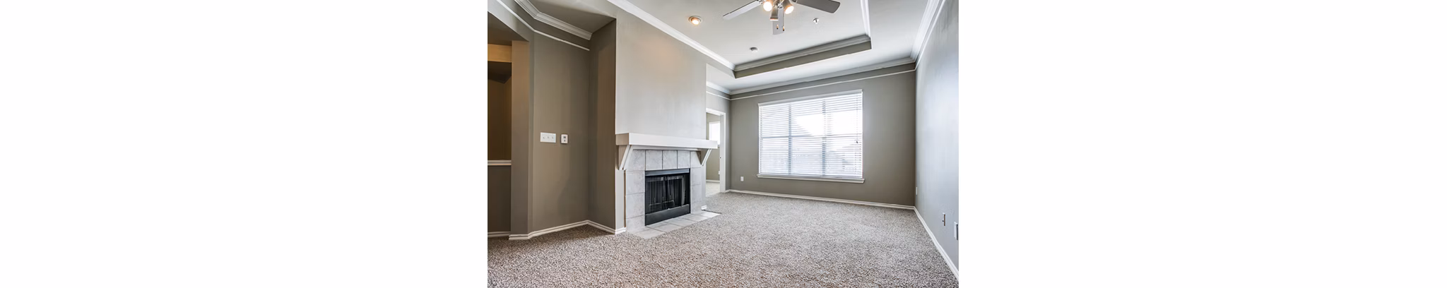 Spacious living room with modern furnishings at Equinox on the Park Apartments
