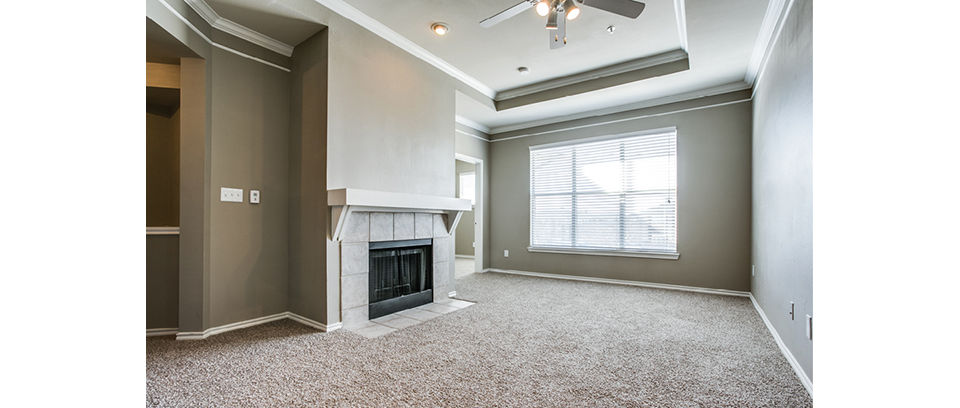Spacious living room with modern furnishings at Equinox on the Park Apartments
