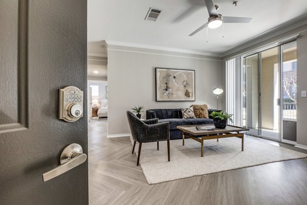 Spacious living room with contemporary decor at Equinox on the Park Apartments