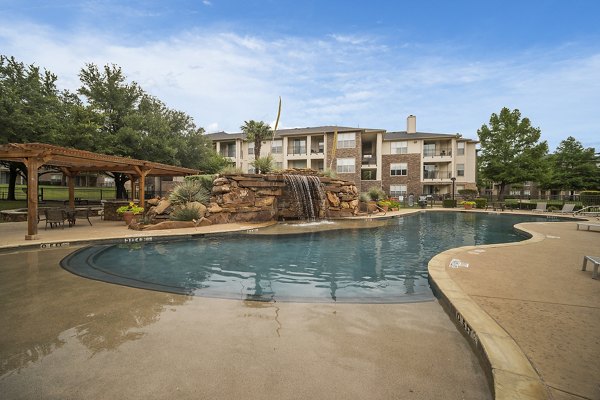 Resort-style pool area at Equinox on the Park Apartments, offering luxury relaxation and recreation