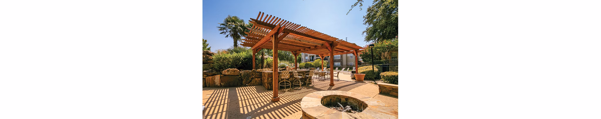 Cozy outdoor fire pit at Equinox on the Park Apartments, perfect for relaxing evenings in a luxury setting