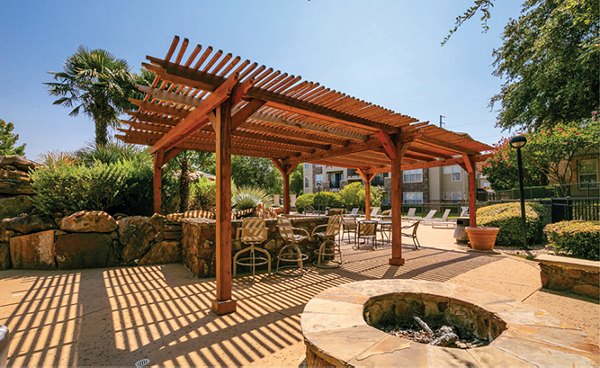 Cozy outdoor fire pit at Equinox on the Park Apartments, perfect for relaxing evenings in a luxury setting