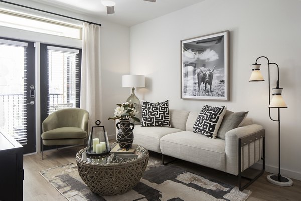 Living room with contemporary design and large windows at Broadstone Cross Creek Ranch Apartments