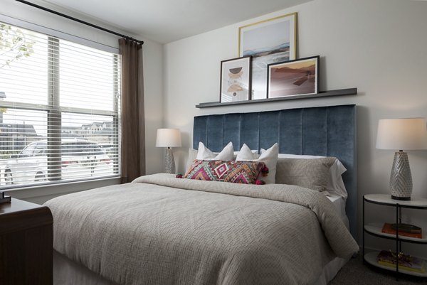 Modern bedroom with elegant decor and natural light at Broadstone Cross Creek Ranch Apartments