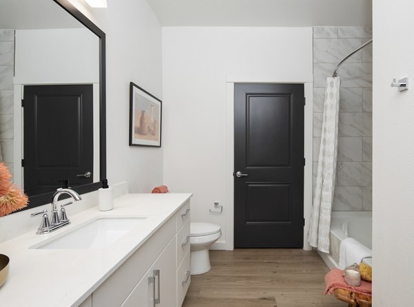 Modern bathroom featuring sleek fixtures and marble countertops in Broadstone Cross Creek Ranch Apartments