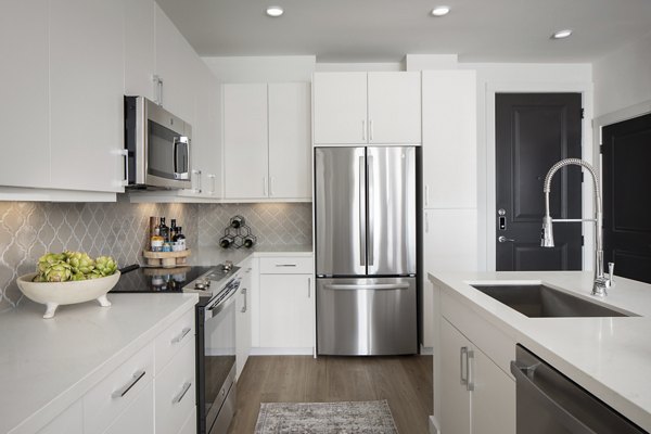 Modern kitchen with granite countertops and stainless steel appliances at Broadstone Cross Creek Ranch Apartments
